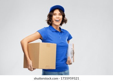 Mail Service And Shipment Concept - Happy Smiling Delivery Girl In Blue Uniform With Parcel Box And Clipboard Over Grey Background