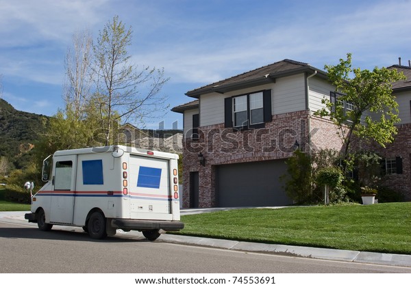 Mail\
truck makes a stop in a residential\
neighborhood.