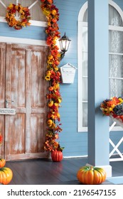 Mailbox On Wall At Entrance Of House. Halloween Design Home. Entrance Of House Door Decorated With Autumn Leaves For Holiday. Fall Festive Yellow Leaf, Twigs And Pumpkins On Facade Home. 
