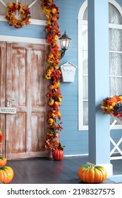 Mailbox On Wall At Entrance Of House. Halloween Design Home. Entrance Of House Door Decorated With Autumn Leaves For Holiday. Fall Festive Yellow Leaf, Twigs And Pumpkins On Facade Home. 
