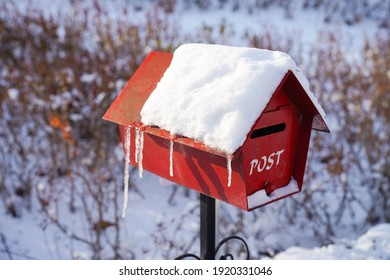 A Mailbox With Snow Piled Up In Winter           