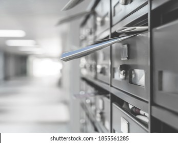 Mailboxes in the condominium. Mailboxes filled. Mail boxes filled of leaflets and letters. Defocused blurry background.