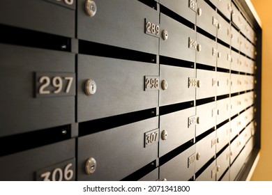 Mailboxes for letters and correspondence. Modern black mailboxes with numbers in the lobby of a residential or office building - Shutterstock ID 2071341800