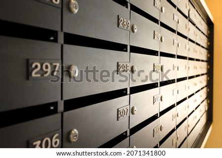 Mailboxes for letters and correspondence. Modern black mailboxes with numbers in the lobby of a residential or office building