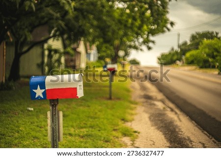 Mailboxes Painted as the Texas State Flag in Grass Lawns Along Empty Street Road in Suburban Texas