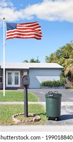 Mailbox,Trash Container And American Flag On Property Of Suburban Ranch House Blue Sky In Residential Neighborhood USA