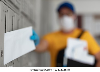 Mailman Delivering Mail With Mail-bag And Protective Mask And Gloves During Virus Pandemic.