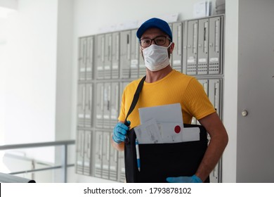 Mailman Delivering Mail With Mail-bag And Protective Mask And Gloves During Virus Pandemic.