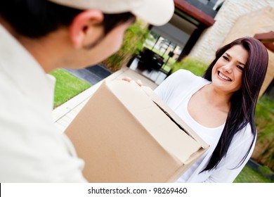 Mailman Delivering A Parcel At A Womans House