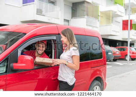 Mailman surprising the girl while she is enjoying her coffe alone .