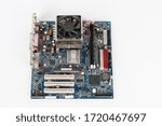 Main board of old desktop computer, CPU cooler fan, memory module in slot on motherboard.