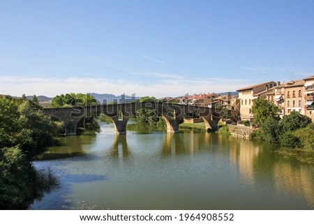 The main bridge over the river with trees from the Puente de la Reina, Navarra