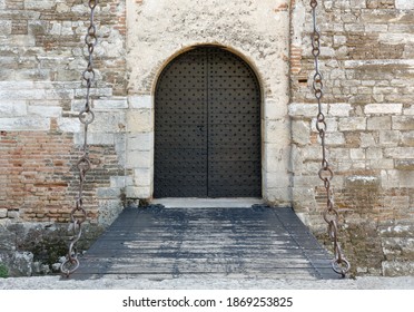 Main Entrance To A Medieval Castle, With Its Drawbridge Over A Moat