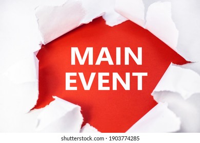 The Main Event Is Written On A Red Background Which Is Located In The Center Of A White Torn Sheet