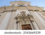 Main facade of baroque Dominican church of St. Maria Rotunda of the 17th century, view view from bottom to top against the sky, Vienna, Austria
