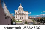 Main facade of National Pantheon aerial timelapse hyperlapse (The Church of Santa Engracia), a 17th-century monument in downtown Lisbon. Clouds on a blue sky. Portugal.