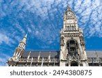 Main facade of the New Town Hall or Neues Rathaus. Building at the northern part of Marienplatz in Munich. Cloudy sky on background. Bavaria, Germany