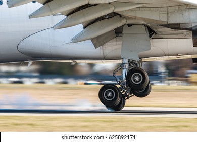 Main Landing Gear Of Big Airplane During Touchdown When Wheel Smoke