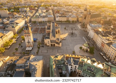 Main Market square or Rynek Glowny with a Town Hall, Sukiennice and St. Mary's Basilica church at sunrise in Krakow, Poland. Aerial view of the Krakow central square in morning. - Powered by Shutterstock