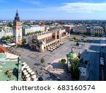 Main Market Square (Rynek), old cloth hall (Sukiennice), town hall tower, Church of St. Adalbert or St. Wojciech and renovated Mickiewicz statue in Krakow (Cracow) Poland. Aerial view.