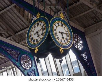 Main multi faced clock hangs from ceiling of Smithfield Market, London, England