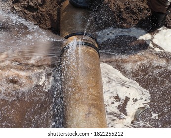 The main pipe is broken or burst and is being repaired - Shutterstock ID 1821255212