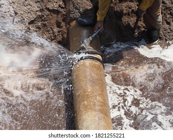The main pipe is broken or burst and is being repaired - Shutterstock ID 1821255221