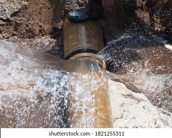 The main pipe is broken or burst and is being repaired - Shutterstock ID 1821255311