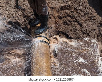 The main pipe is broken or burst and is being repaired - Shutterstock ID 1821255887