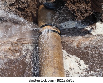 The main pipe is broken or burst and is being repaired - Shutterstock ID 1821255905