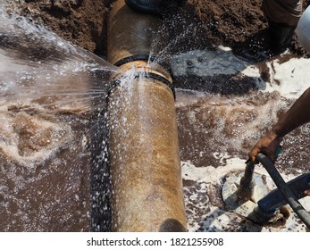 The main pipe is broken or burst and is being repaired - Shutterstock ID 1821255908