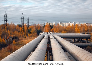 The main pipeline and power lines against the background of the city under construction.