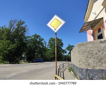 Main Road Traffic Sign On A Corner Of A Countryside Street On A Sunny Day