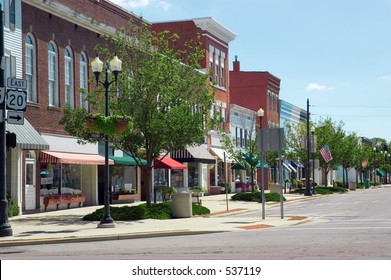 A Main Street In A Typical Midwest Small Town, Complete With U.S. Flags.