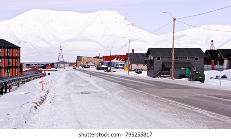 The Main Street View Of The Town Of Longyearbyen, The Largest Settlement And The Administrative Center Of Svalbard,Norway,wooden Colourful Houses At The Clear Sunny Spring Day With Rocks On The Back.