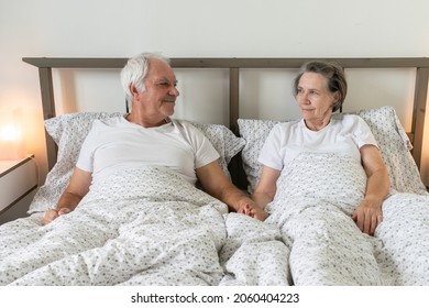 The Main Subject Is Out Of Focus, Senior Aging Married Couple Man Male And Female Woman  Resting Together In Bed At Home Apartment Sexual Problems Dysfunction Happy Smile Love