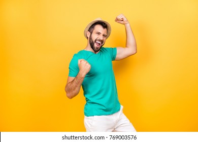 The main task is completed! Yeah! I did it! I reached so long desired success! Happy excited cheerful joyous guy celebrating his victory with raised hands, isolated on yellow background