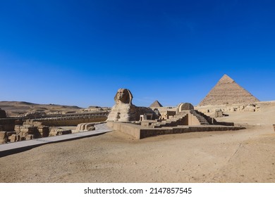 Main View to the Great Sphinx of Giza, is a giant limestone statue with the Great Pyramid in Background in Giza, Egypt