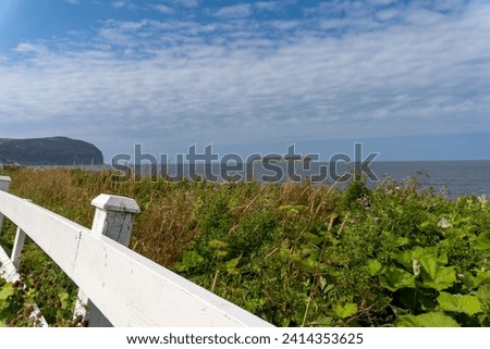 Mainland (La Grand'terre) coast line on Port au Port Peninsula in Newfoundland, Canada. Red Island (L'Île Rouge), Sisters’ Dream School Museum, white fence, 