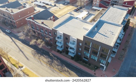 Mainstreet in downtown Oklahoma City with multistory apartment, modern urban living space, spacious stylish loft condos in urban metro complex, parked car along street, rental housing real estate. USA