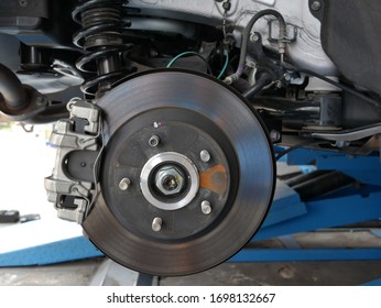 Maintaining Car Brake Disc At Repair Service Station.