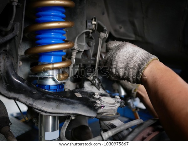 maintaining a car shock\
absorbers at\
garage.