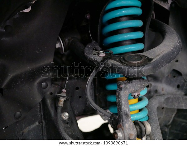 maintaining a car shock\
absorbers at\
garage.