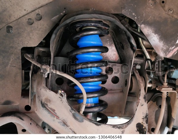 maintaining a car shock absorbers at repair service\
station. 