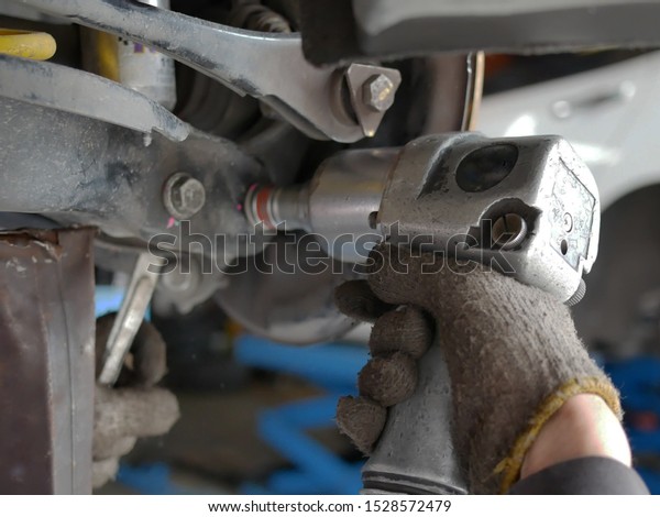 maintaining a car shock absorbers at repair\
service station.