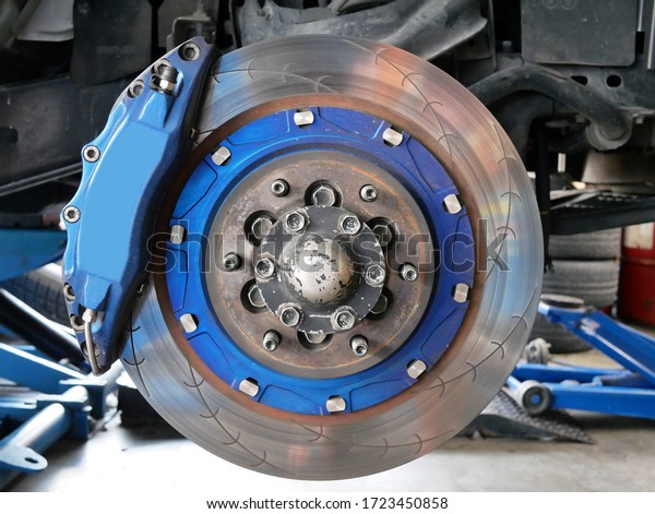 maintaining car wheel brake disc at repair\
service station.