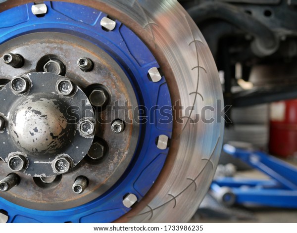 maintaining car wheel brake disc at repair\
service station.