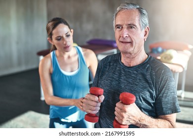Maintaining muscle mass with regular exercise. Shot of a senior man working out with his physiotherapist. - Shutterstock ID 2167991595