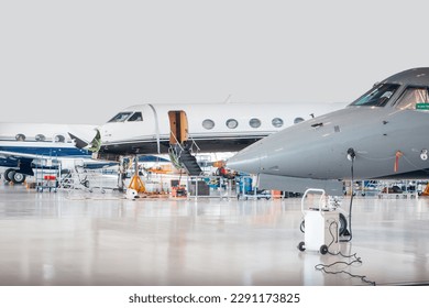 Maintenance of aircraft in the hangar where technical inspection is carried out - Powered by Shutterstock