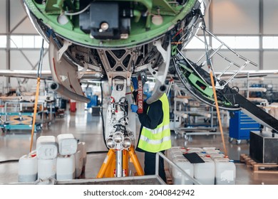 Maintenance Of Airplane In The Large White Hangar